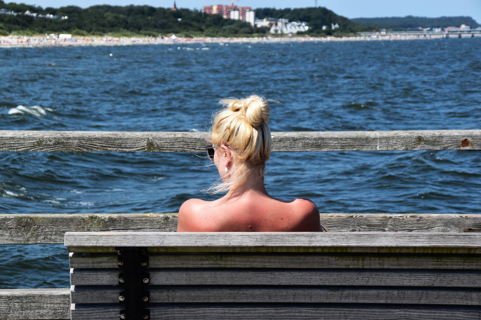 Relaxing moment by the sea in Heringsdorf, Germany, featuring a woman enjoying the peaceful seaside view.